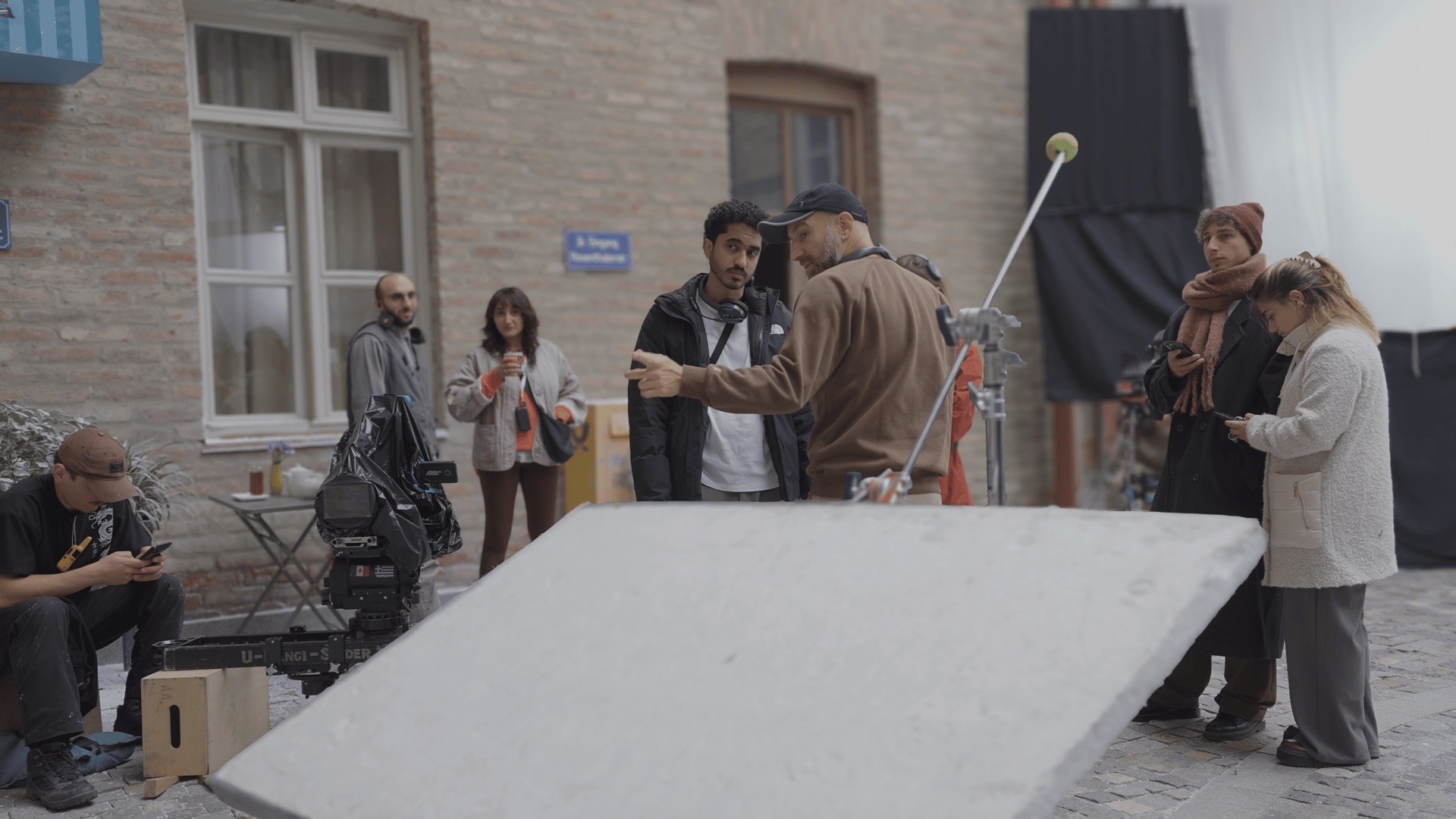 Abdullah Bamajboor and crew member looking at the framing of a scene through a camera